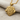 Twin Lion Pendant, gold vermeil, front view on fabric