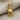 Hockey Goalie Mask Pendant, gold vermeil, front view on fabric