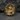 Detailed high-relief Renaissance sculpture design of the Self Made Man ring resting on a dark stone surface