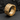 Close-up of the 14K gold vermeil over sterling silver No Days Off Ring resting on a rugged dark stone texture