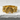 Close-up view of the organic textured ring resting on a white plaster surface highlighting the metal details