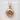 Curved Dolphin Pendant, rose plated silver, front product view on white block