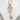 Scroll Heart Key Pendant, rose gold plated silver, front view on stone