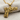 Rose Wrapped Handgun Pendant, gold vermeil, front view on fabric