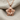 Layered Lotus Pendant, rose gold, front view on fabric