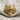 Wolf Pelt Skull Ring, gold vermeil, front view on fabric