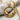 Two Mice Pendant, gold vermeil, front view on textured fabric