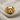 Detailed boxer dog ring resting on a textured linen surface, displaying the handcrafted luxury finish and deep engraving