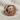 Pug Dog Ring, rose gold plated silver, front view on textured fabric
