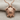 Gliding Sea Turtle Pendant, rose gold finish, product photo on fabric