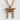 Hammered Torii Gate Pendant, rose gold, front view on textured wall