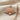 Hand fan pendant, rose gold, angled view on textured fabric