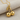 Twin Cherry Pendant, gold vermeil, angled view on fabric