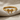 Petite Bow Ring, gold vermeil, front view on textured fabric