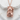 Maneki Neko Pendant, rose gold, front view on stone surface