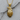 Close-up of 925 sterling silver golden eagle pendant resting on textured grey wood next to a small twig