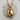 Close-up view of the detailed 14K gold vermeil boxing gloves pendant resting beautifully on a natural wood surface