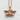 Cherub Angel Pendant, rose gold, front view on textured wall