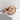 Great Wave Signet Ring in rose gold, angled view on stone