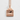 Mount Fuji Pendant, rose gold, front view on textured plaster