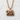 Hokkaido Bear Pendant, rose gold, front view on textured wall
