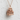Himeji Castle Pendant, rose gold, angled product photo on textured wall