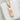 Wind Kanji Pendant in rose plated silver, angled view on stone