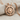 Horned Hittite Sun Pendant, rose gold finish on fabric backdrop