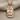 Teshub Storm God Pendant, rose gold finish, front view on fabric