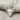 Hittite Bull Pendant, polished silver, front view on fabric