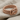 Gordian Knot Ring, rose gold, angled view on fabric