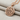 Peace Love Pendant, rose plated silver, angled view on fabric