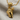 Microphone Fist Pendant, gold vermeil, angled view on linen fabric