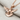 Peace Dove Pendant, rose plated silver, angled view on fabric