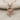 Rose Heart Pendant, rose gold, product photo on textured fabric