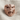 Lobotomy Skull Ring, rose gold, front view on textured fabric