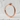 Viper Ouroboros Ring, rose gold, product photo on textured surface