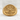 Close-up of gold vermeil Libra signet ring with intricate scales motif placed on textured white background