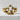 Half Skull Jaw Ring, gold vermeil, front view on stone surface