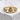 Front view of gold Claddagh ring with detailed crown and heart motif displayed on a textured stone block