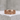 Side view of Celtic Claddagh ring with detailed band pattern displayed on textured concrete block surface