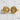 Pair of detailed gold three headed dragon sigil cufflinks displayed on rustic white textured backdrop