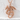 Serpent Dragon Pendant, rose gold, product photo against textured wall