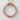 Circular Ouroboros Snake Pendant, rose gold, product photo on textured wall