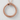Circular Ouroboros Snake Pendant, rose gold, product photo on textured wall