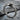 Ouroboros Band Ring, oxidized silver, angled view on rock
