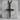 Three Nails Cross Pendant, black rhodium, front view on concrete block