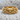 Horned Baroque Skull Ring, gold vermeil, front view resting on textured stone