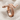 Spiral Serpent Ring in rose gold finish, front view on fabric