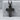 Corpus Christi Crucifix Pendant, black rhodium, front view against grey stone